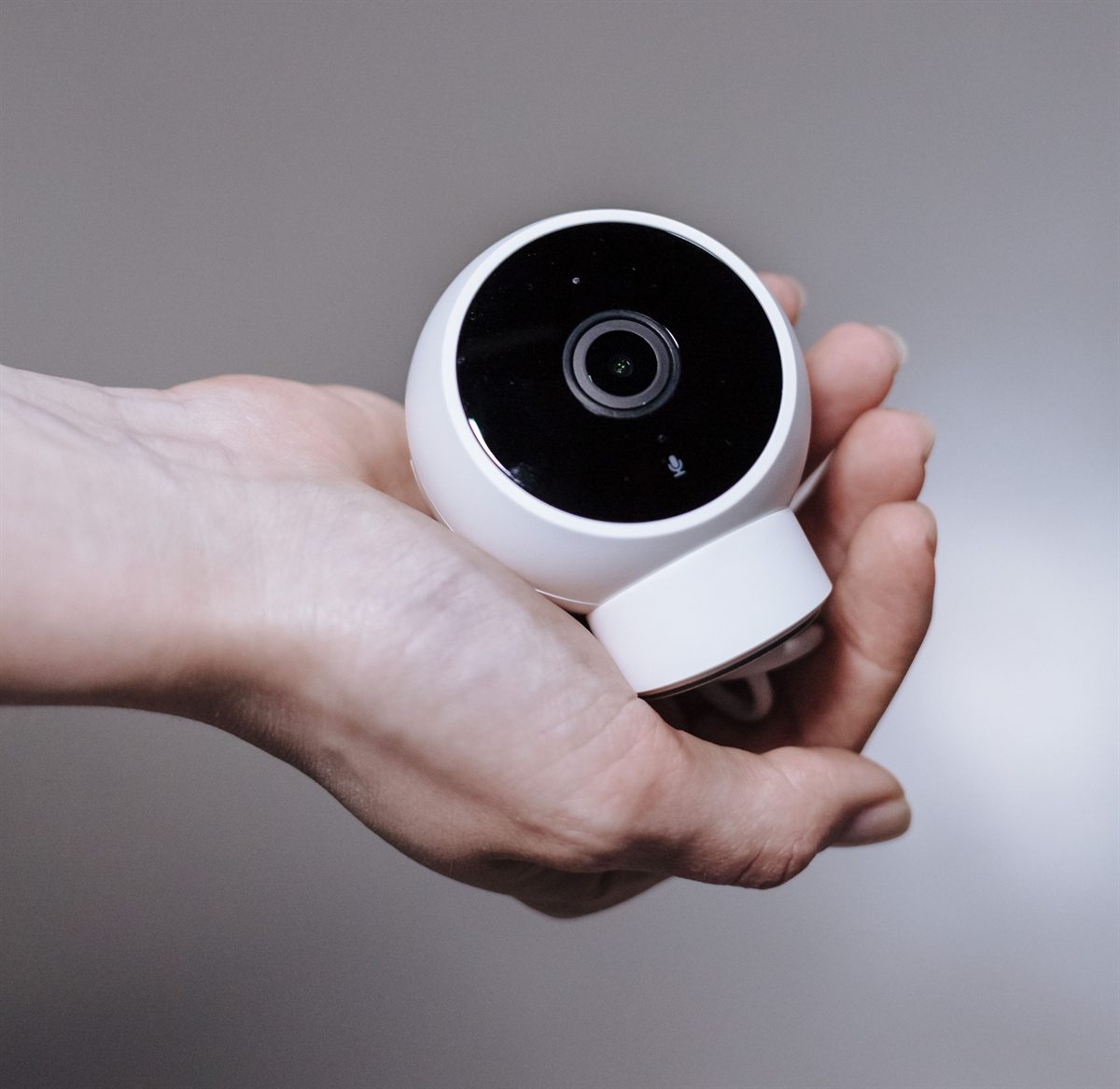 A dome CCTV camera held in hand before installation
